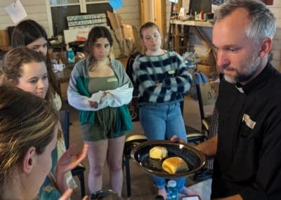 Andrew Rickel Serving Communion to Students